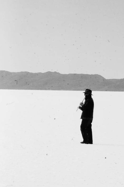 a man standing on top of snow covered ground