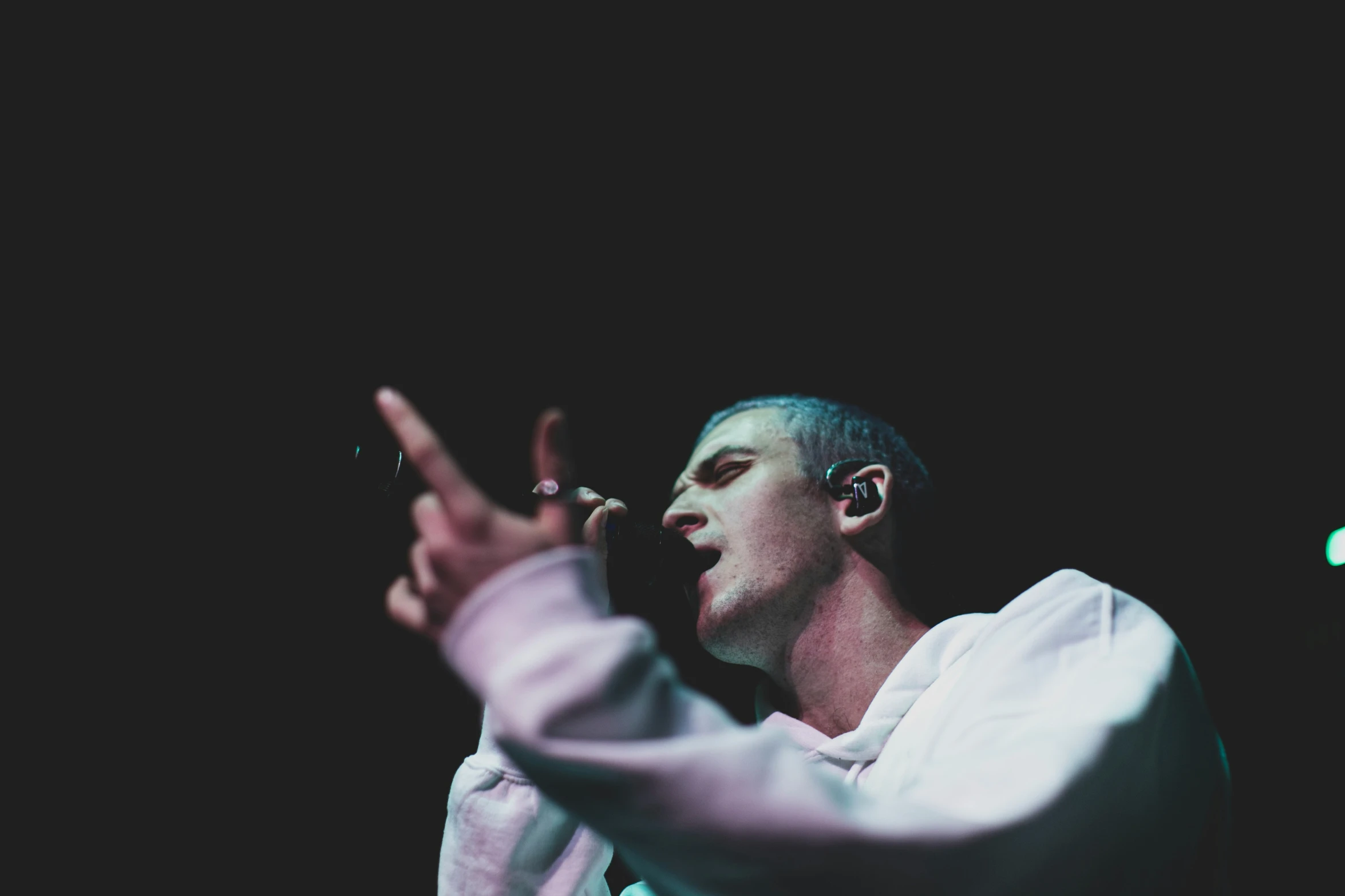 a male singer is standing in front of a microphone