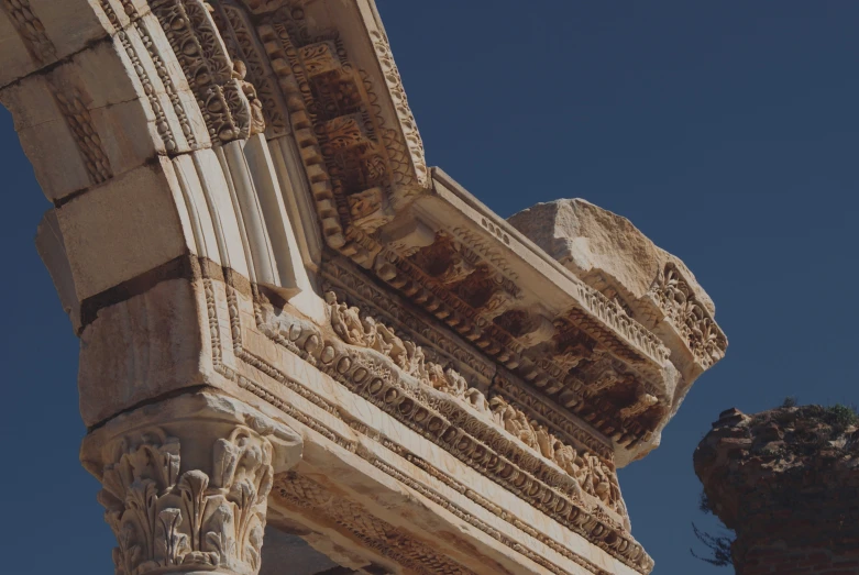 a building with an unusual pillar and elaborate carvings