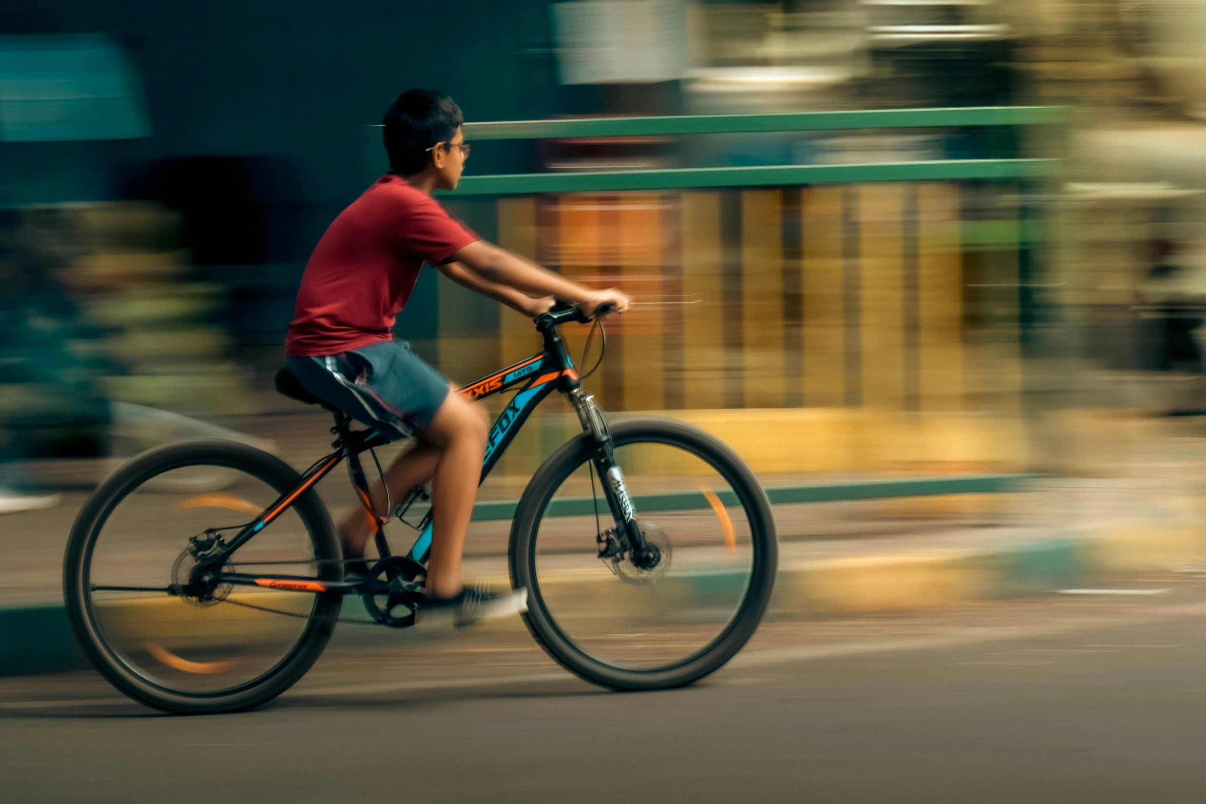 a man riding a bike past a building in the street