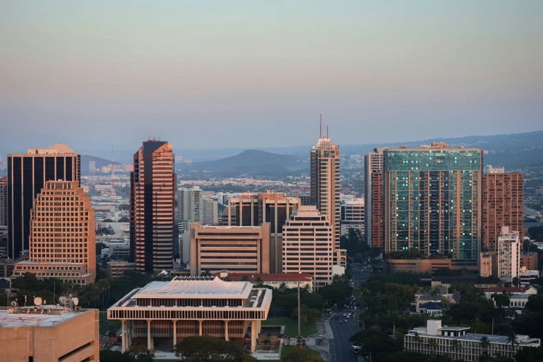 large city buildings stand behind smaller city buildings