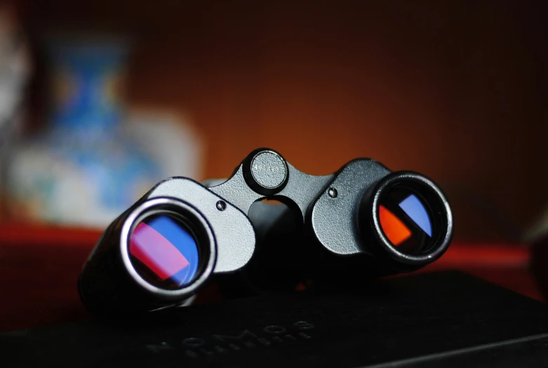 two binoculars resting on top of each other