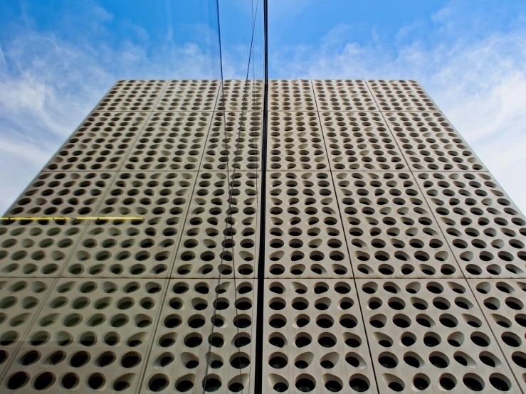 the side of a building with hole holes on it