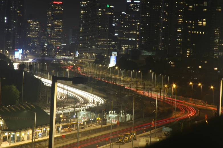 a city skyline with buildings and traffic at night