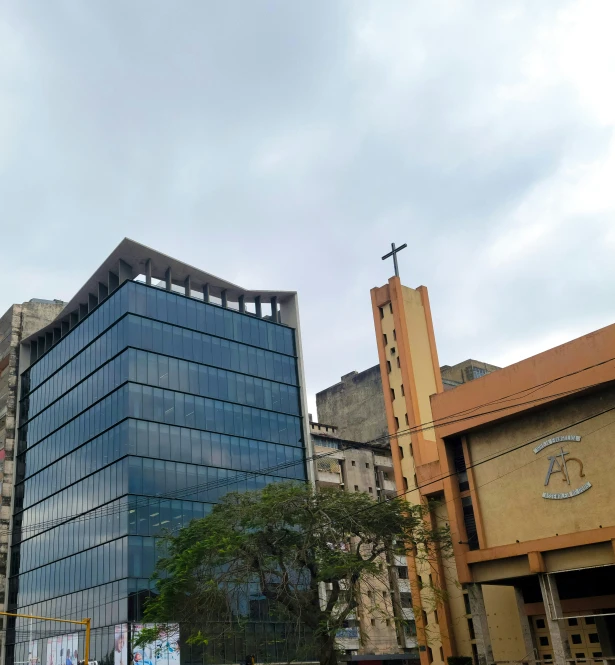 an older building sitting in front of a taller building