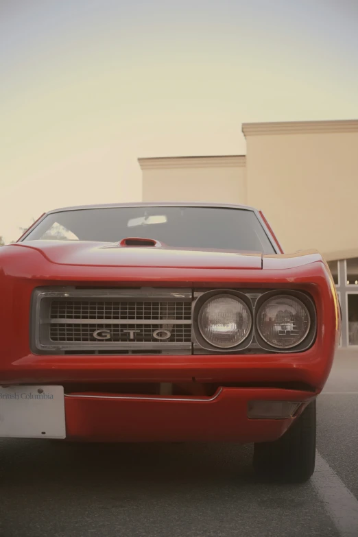 red car with grilles on it's front parked in a lot