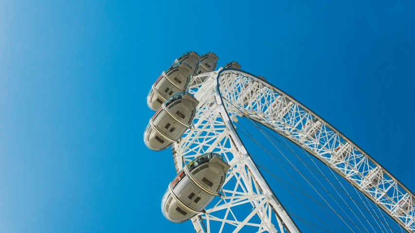 a large ferris wheel is against a clear blue sky