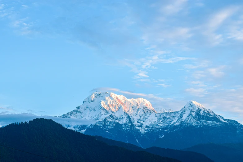 snowy mountains rise up in the distance as sun sets