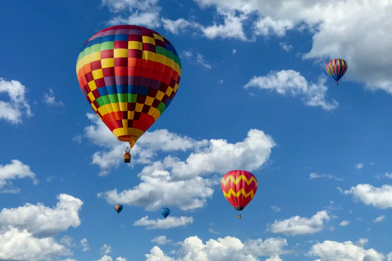 many colorful  air balloons fly through the air