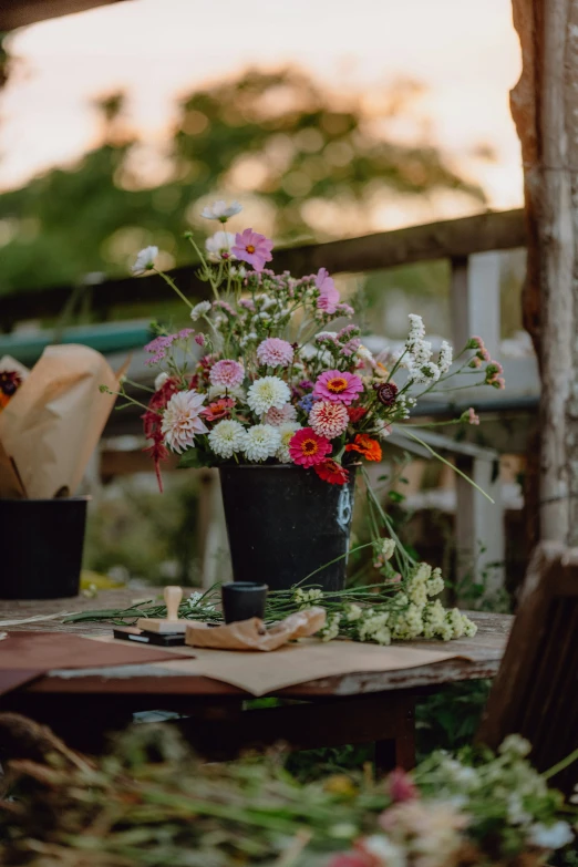 two small vases with flowers on a table