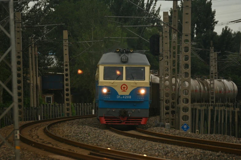 train on railroad tracks at dusk, with a few other tracks nearby