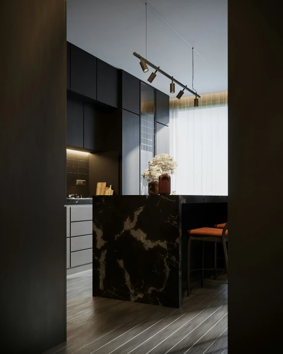 a black and gold kitchen with chandelier above the bar