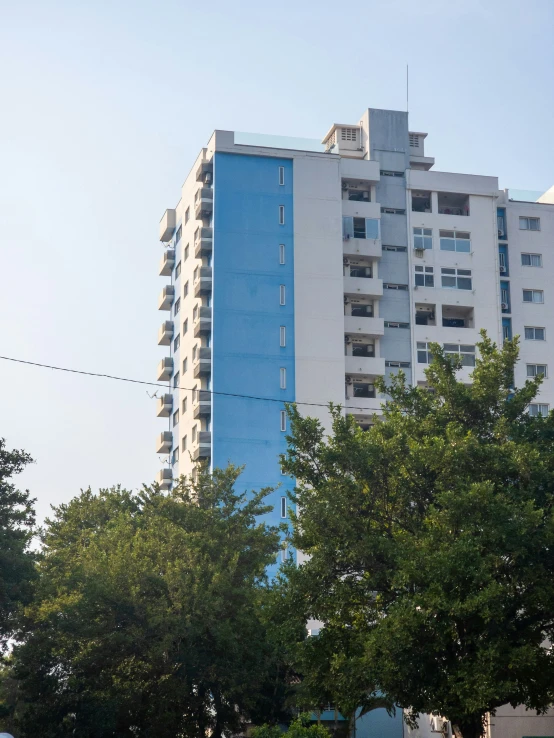 a large blue building that is sitting on the side of a road