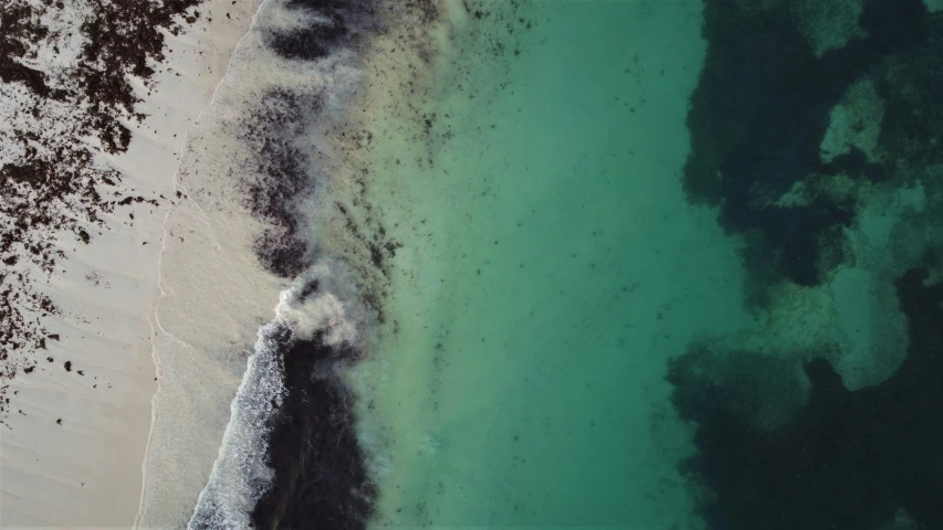 an aerial view of the ocean near the shore