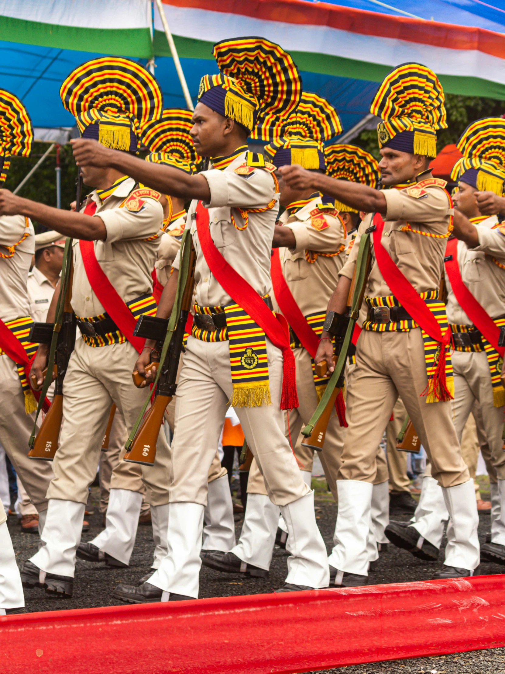 a marching group in the parade with their uniforms and accessories