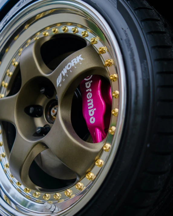 a metallic wheel with some gold rivets in it