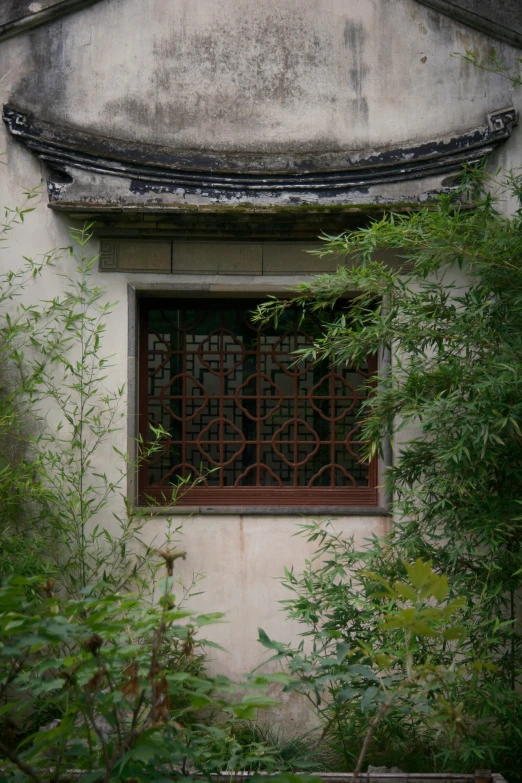 a window sitting under a roof in a window frame