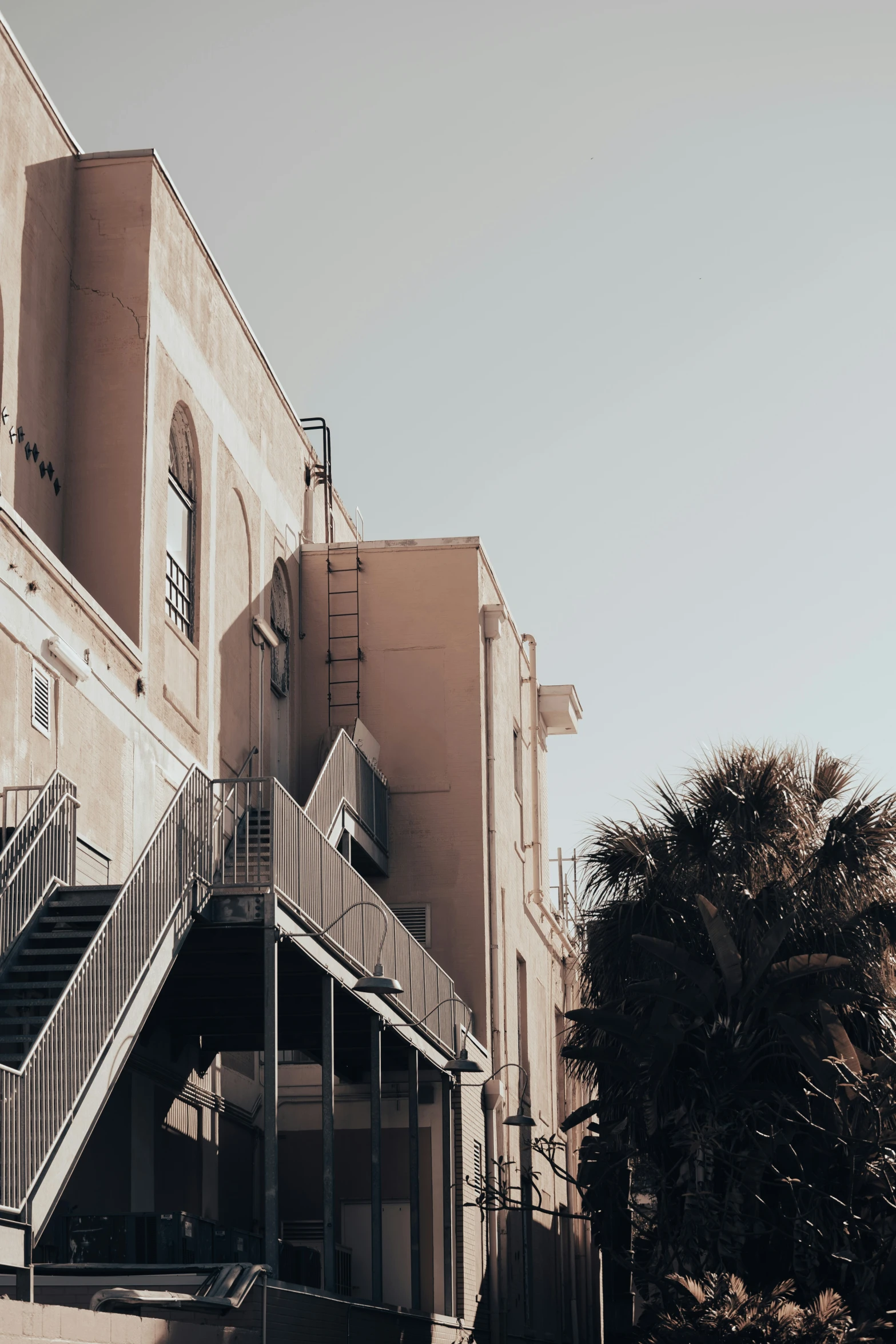 several windows, staircases, and street signs on the outside of buildings