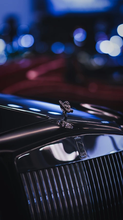 closeup s of the chrome of the front of a shiny black vehicle