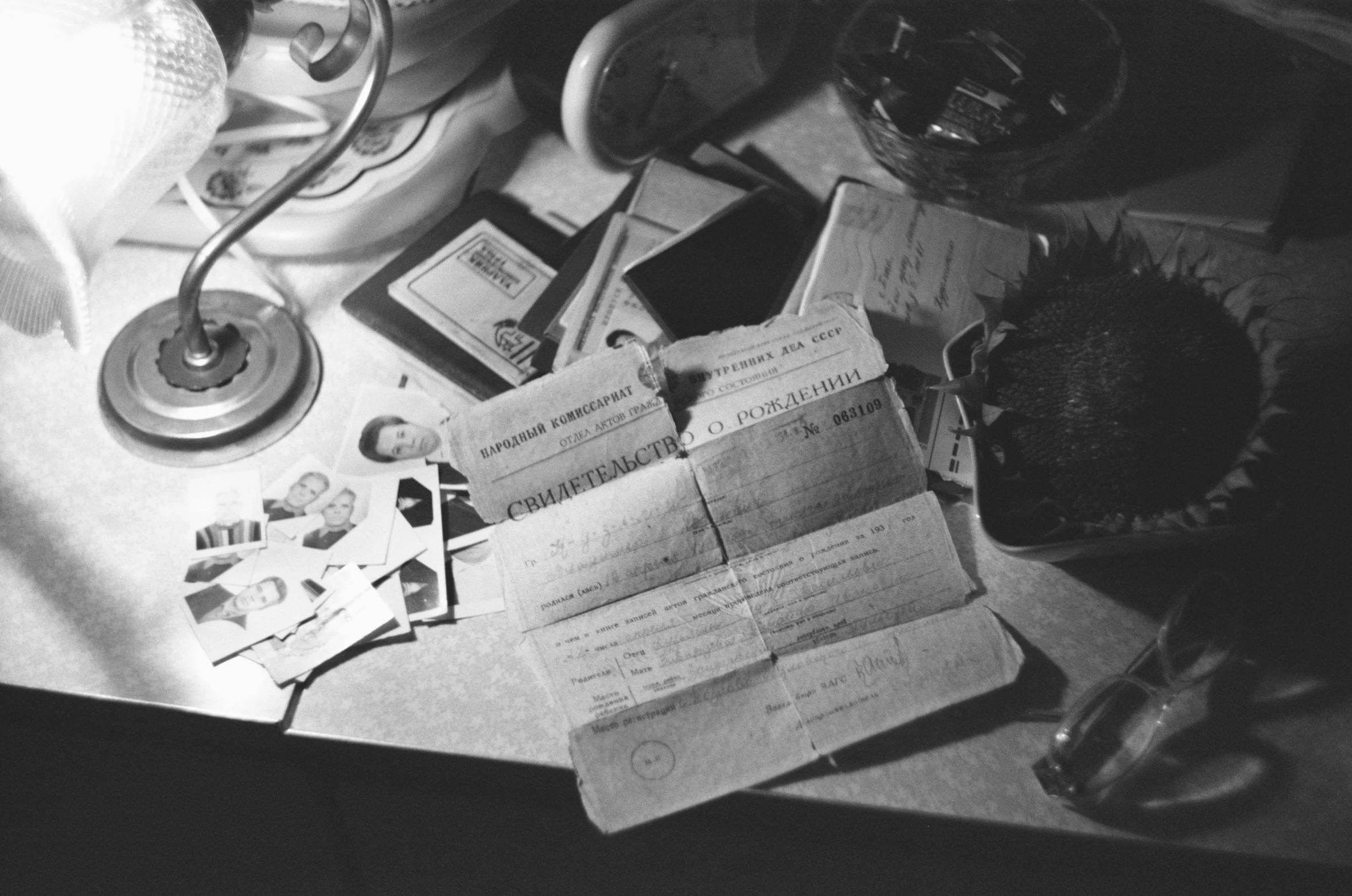 an old desk with papers on it and a light