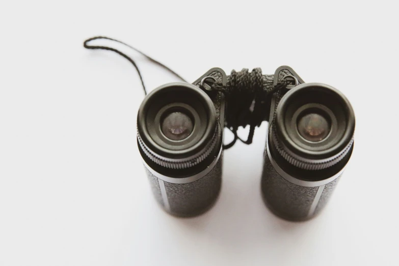 two black speakers are on a white surface