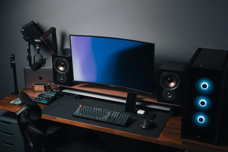 a computer with speakers and a monitor on a desk