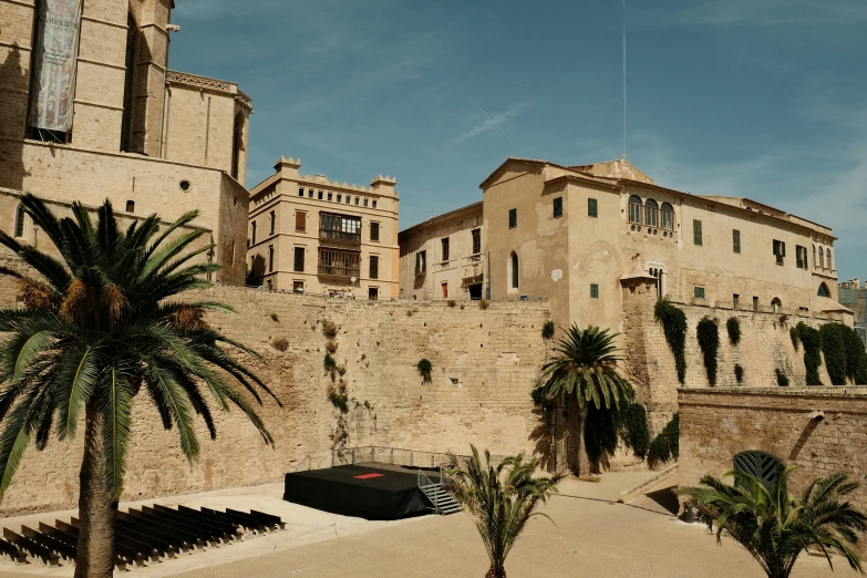 a beach area with palm trees next to buildings