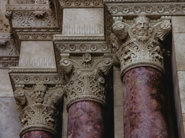 three stone pillars with an intricately designed pattern