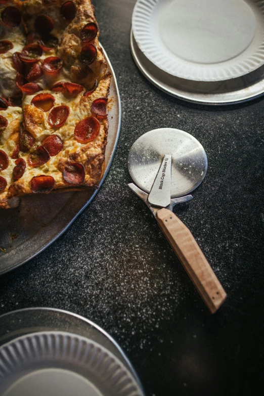 a plate with some pizza on it and a pizza peel