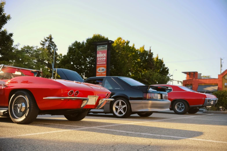 a couple of old style cars parked in a lot