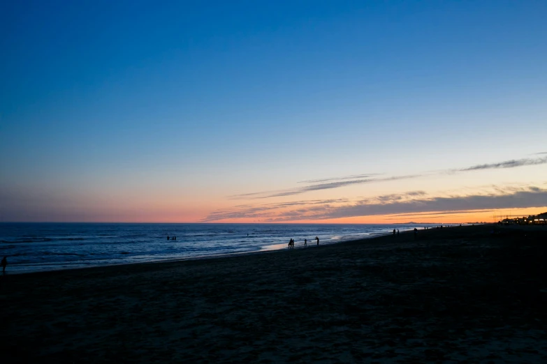 a sunset on the ocean with a sky background