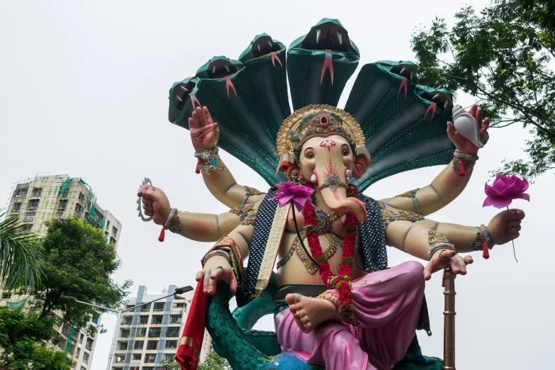 a statue of an elephant god sitting on top of a bench