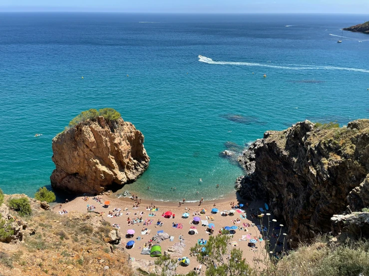 a beach is crowded with people on it