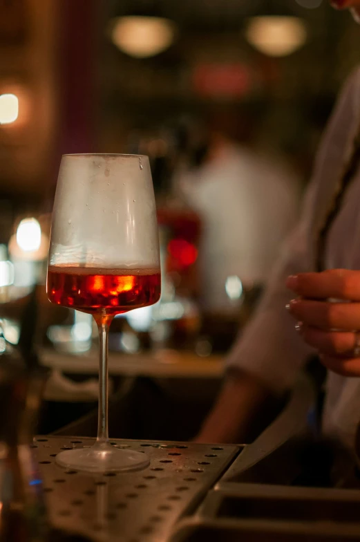 a closeup of a glass of wine on a bar