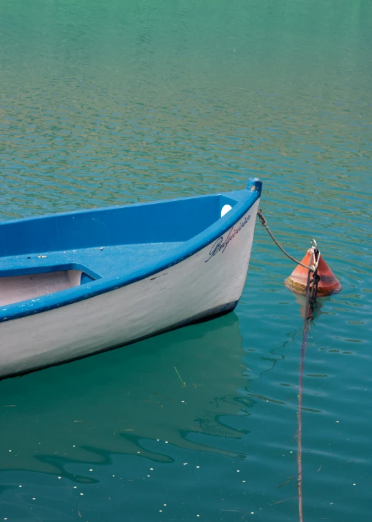 a small boat sitting in some very clear water