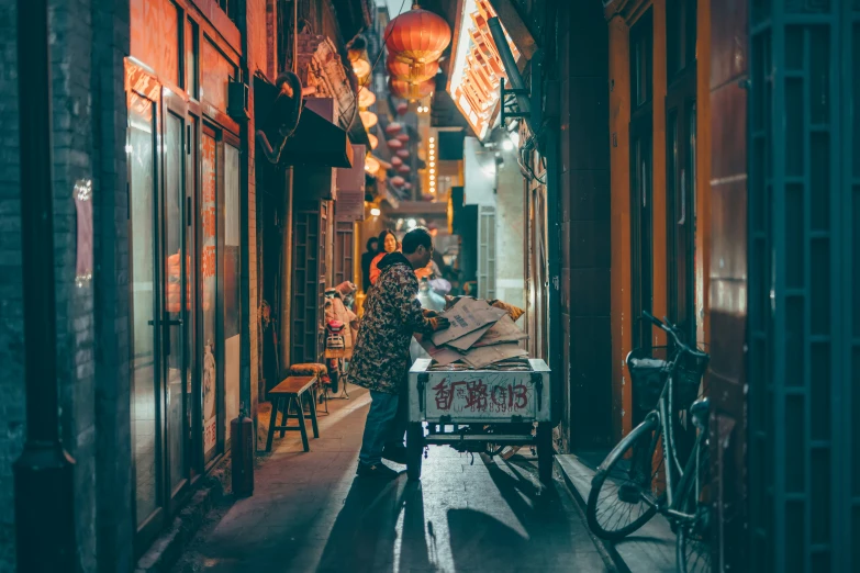 woman hing an outdoor cart through a building