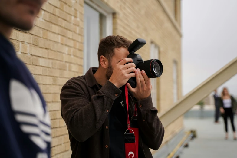 a young man taking pictures on his cellphone with the camera