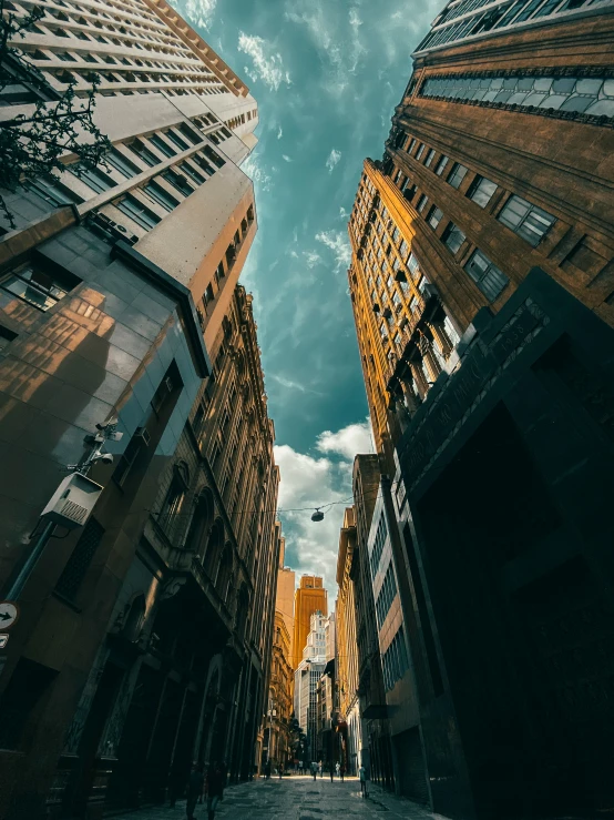 a city street lined with tall buildings under a cloudy sky