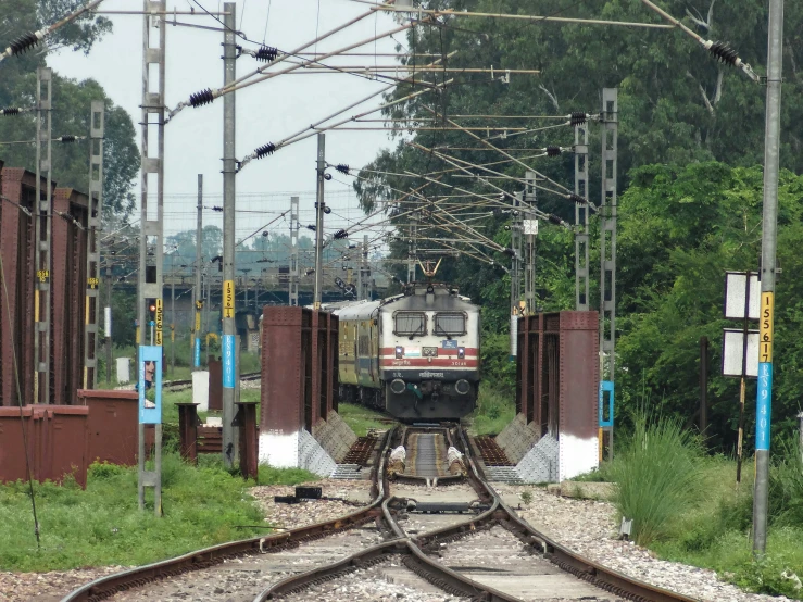 a train crossing a railroad track between many structures