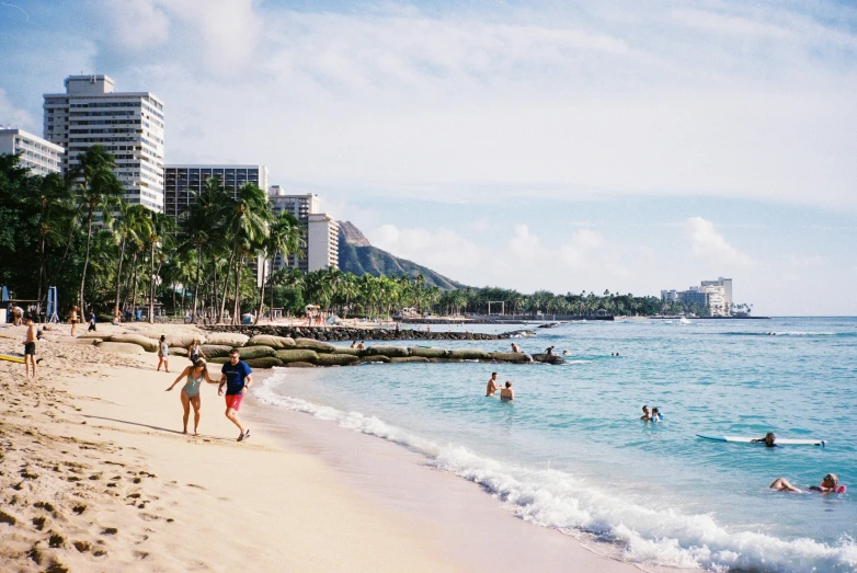 the people are having fun in the water on the beach