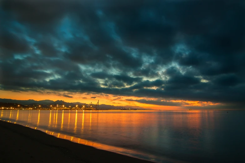 a view of the ocean at night with sky and water