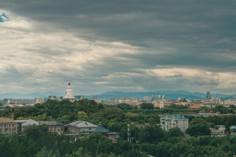 a very long clock tower towering over a city