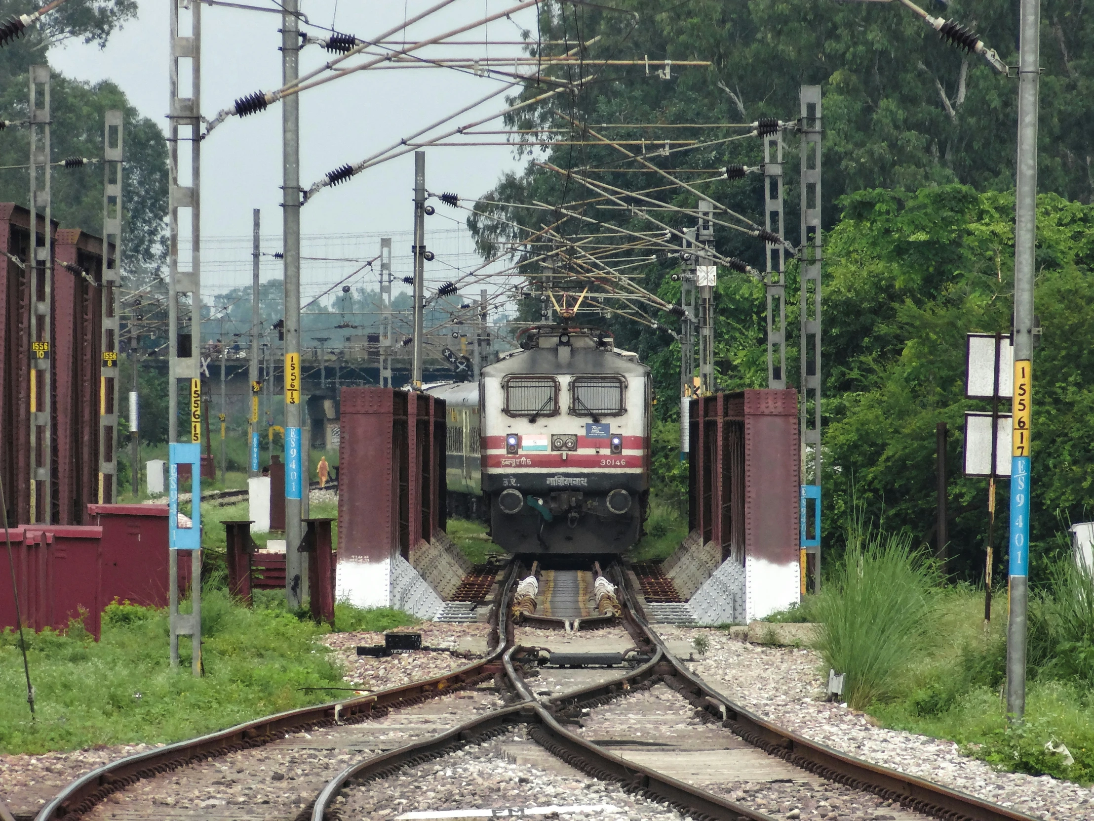 there is a train coming down the tracks through some town