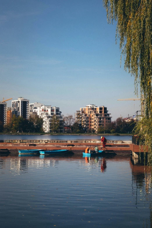 some canoes in water by tall buildings