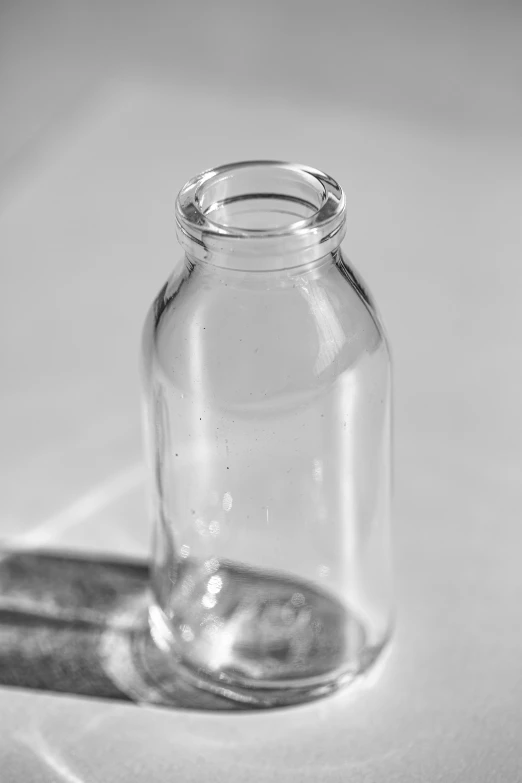 a glass bottle sits next to a lighter