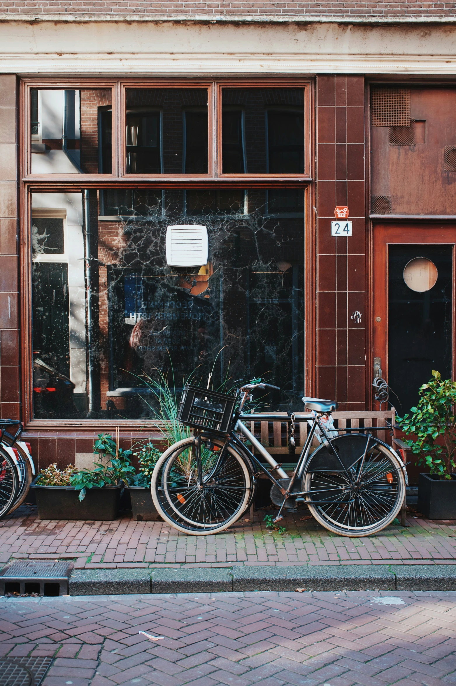 two bikes are parked outside of a window