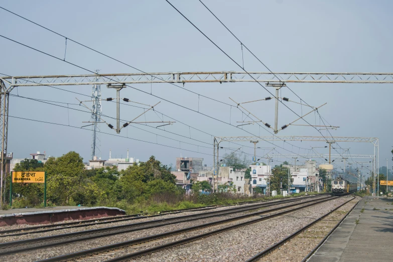 a train track that is lined up with power lines