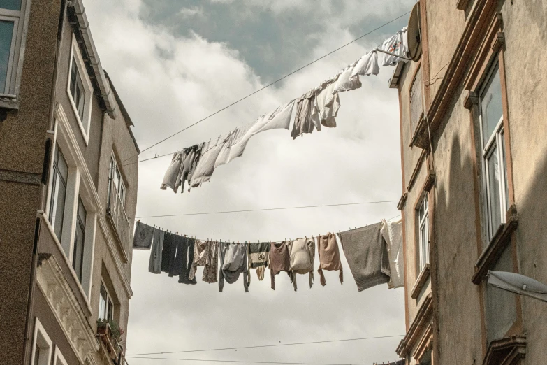a line of clothes hanging outside of some buildings