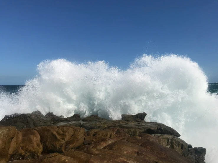 the waves roll over the rocks by the ocean