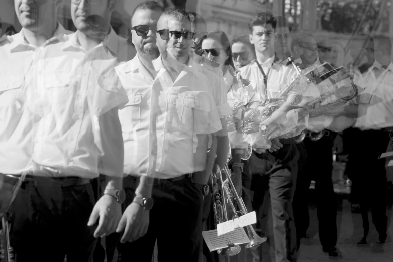 a black and white po of men in uniforms and sunglasses